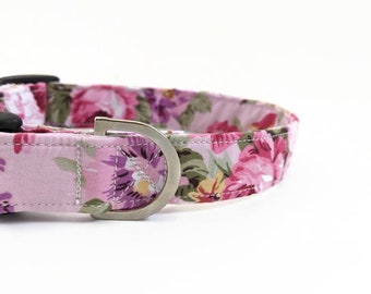 May include: A pink floral dog collar with a silver metal buckle.