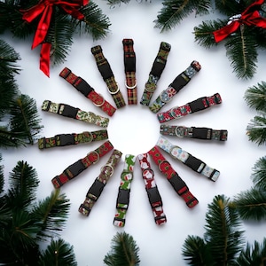 May include: A collection of 12 festive dog collars with various Christmas-themed patterns, including Santa, reindeer, snowflakes, and plaid. The collars are arranged in a circle on a white background.