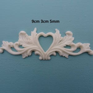 May include: White decorative trim with a heart-shaped cutout, measuring 9cm by 3cm by 5mm.