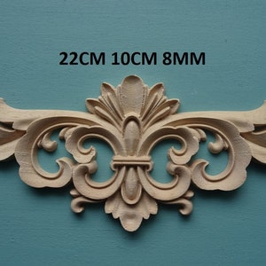 Puede incluir: Una talla de madera decorativa con un diseño floral. Mide 22 cm por 10 cm por 8 mm.