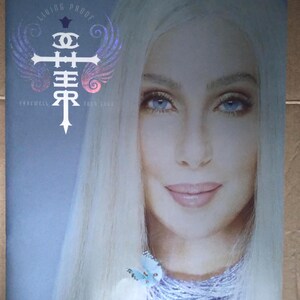 May include: A promotional image for the "Living Proof Farewell Tour 2005" featuring a close-up of a woman with long, platinum blonde hair and blue eyes. The image includes the tour logo and a butterfly.