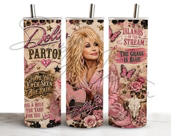 May include: A cylindrical metal tumbler with a straw featuring a collage of Dolly Parton, pink butterflies, roses, a cow skull, and song titles including Islands in the Stream, The Grass is Blue, and Have You Ever Seen The Rain in pink and brown.