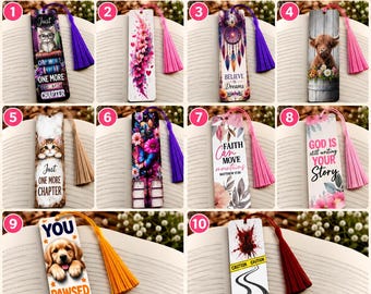 May include: A collection of ten rectangular bookmarks featuring various designs including animals, flowers, and inspirational text. Each bookmark is attached to a colored tassel and displays unique graphics such as a cat, a dog, a highland cow, and motivational quotes.