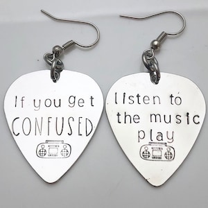 May include: A pair of silver guitar pick earrings with a radio graphic and the text "If you get confused listen to the music play".