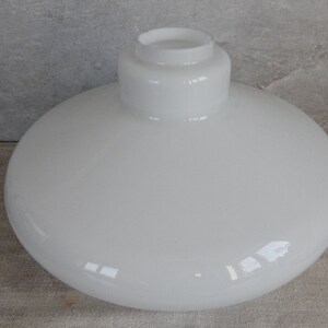 May include: White frosted glass lampshade with a rounded, bowl-like shape. The shade has a smooth, glossy finish.