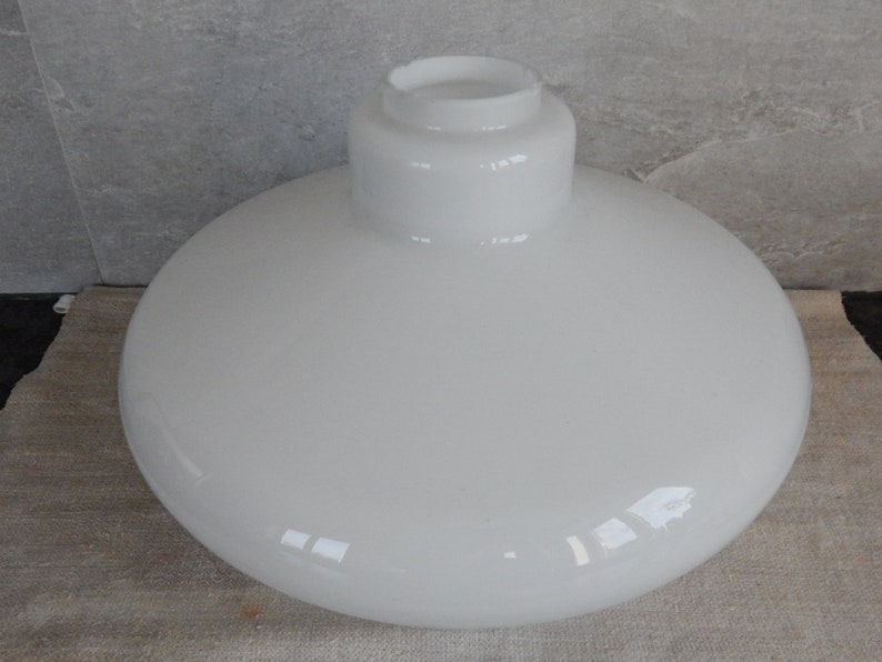 May include: White frosted glass lampshade with a rounded, bowl-like shape. The shade has a smooth, glossy finish.