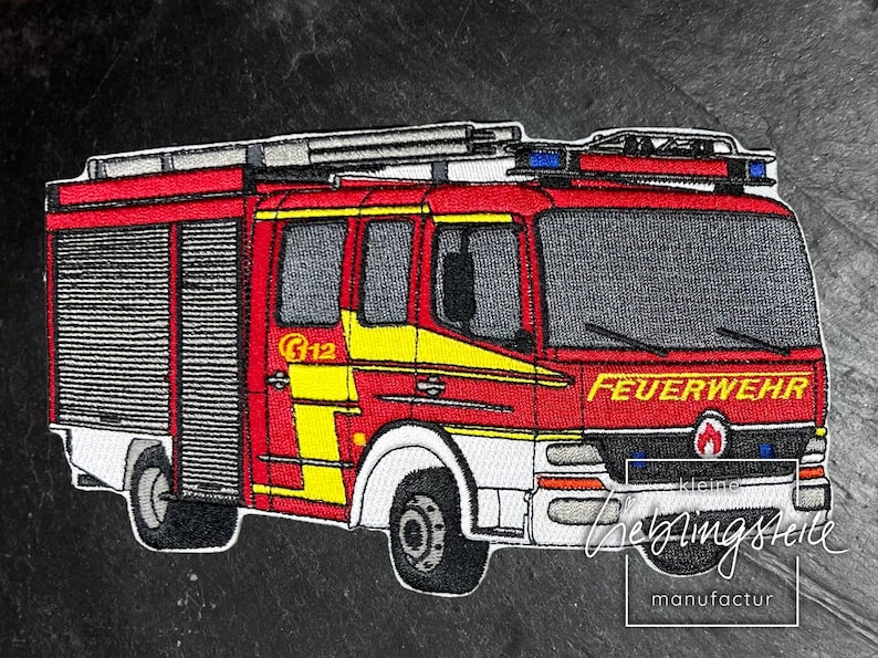 May include: Red and white fire truck with the word "FEUERWEHR" on the front. The truck has a ladder on top and a yellow stripe on the side. The truck is a patch.