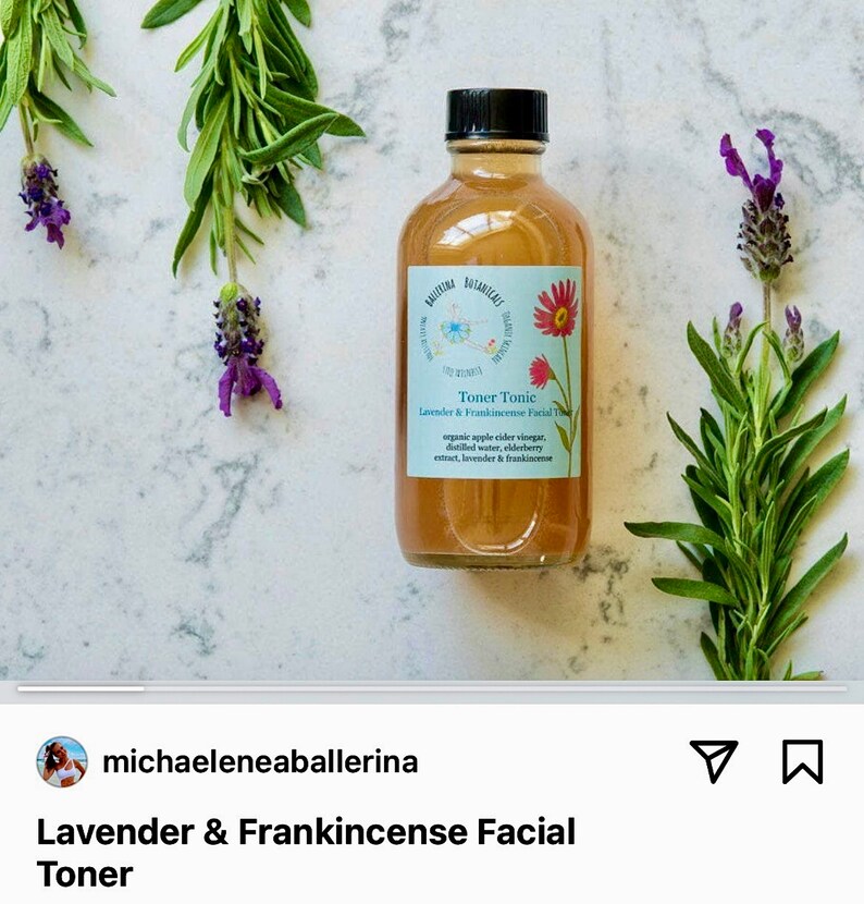 May include: A clear glass bottle with a brown liquid inside. The bottle is labeled "Toner Tonic Lavender & Frankincense Facial Toner" and lists the ingredients as organic apple cider vinegar, distilled water, elderberry extract, lavender & frankincense. The bottle is surrounded by lavender flowers and green leaves.