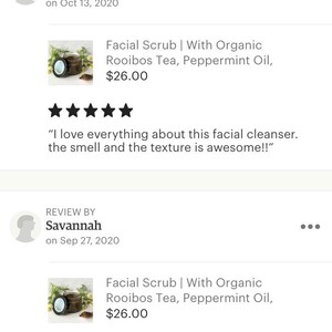 May include: Facial scrub in a glass jar with a brown lid. The scrub is made with organic rooibos tea and peppermint oil. The jar is sitting on a white background. The product is priced at $26.00.