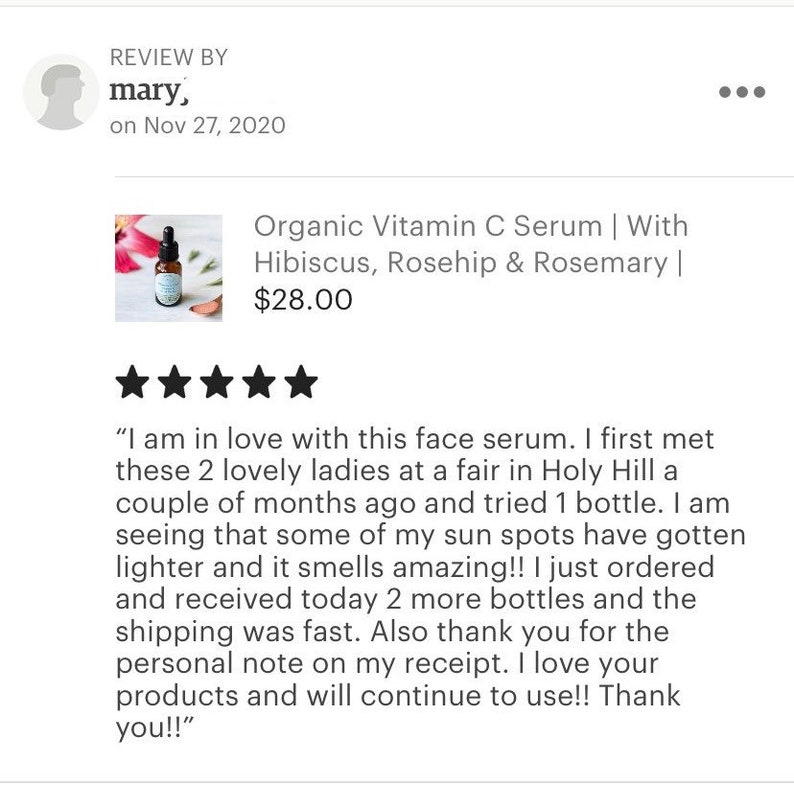 May include: A glass bottle of organic vitamin C serum with a dropper. The bottle is labeled with the product name and ingredients, including hibiscus, rosehip, and rosemary. The product is priced at $28.00.