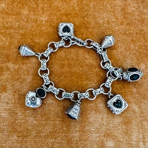 May include: A set of three ceramic mugs with a speckled, matte finish. The mugs are in shades of cream, light gray, and dark gray. Each mug has a simple, minimalist design and a rounded handle.