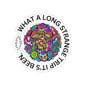 May include: A white sticker with a colorful psychedelic mushroom design and the text "It's a long strange trip, what a been."