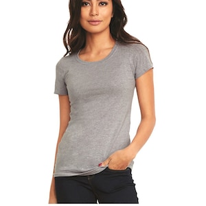 May include: A heather gray scoop neck t-shirt with short sleeves. The model is wearing the shirt with blue jeans.