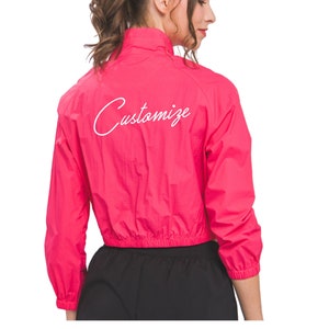 May include: A pink cropped jacket with a white "Customize" text on the back.