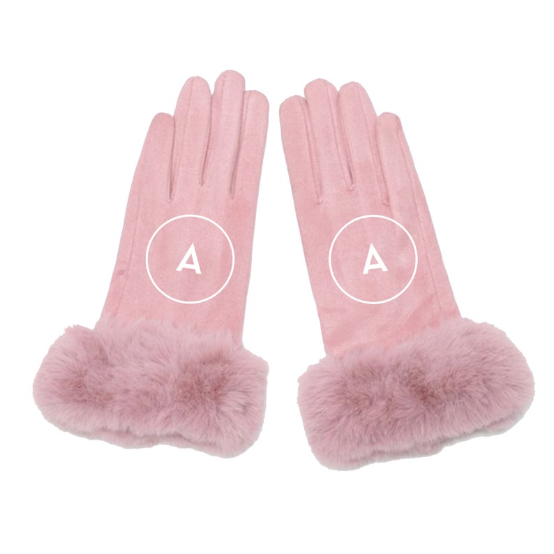 May include: A pair of pink gloves with a faux fur cuff. The gloves are made of a soft, suede-like material. The letter "A" is printed on each glove.