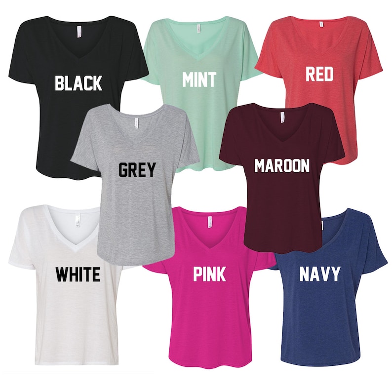 May include: Eight V-neck shirts in different colors, including black, mint, red, grey, maroon, white, pink, and navy. Each shirt has a different color word printed on the front.