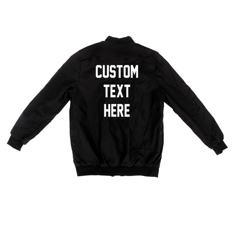 May include: Black bomber jacket with white text on the back that says "CUSTOM TEXT HERE".