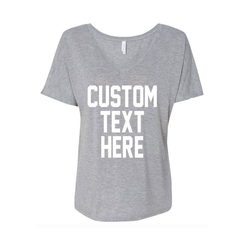 May include: Gray V-neck t-shirt with the text "CUSTOM TEXT HERE" printed in white.