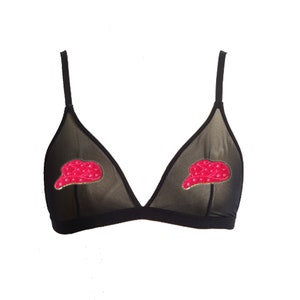 May include: A black sheer triangle bra with red and gold embroidered caps on the cups.