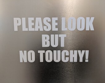 May include: White text on a silver background reads "PLEASE LOOK BUT NO TOUCHY!"