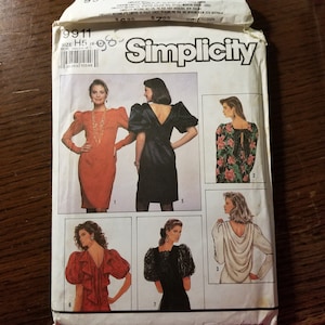 May include: Simplicity sewing pattern number 9911 for a dress with a variety of styles. The pattern includes six different views of the dress, each with a different neckline, sleeve, and back detail. The pattern is for sizes H5 (8-14).