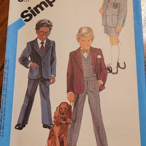 May include: A Simplicity sewing pattern envelope 6611 for child size 4. The cover features illustrations of three outfits: a blue suit, a dark blazer with grey trousers, and a jacket with shorts. A brown dog is shown next to the central figure.