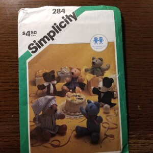 May include: Simplicity sewing pattern number 284, The Vanessa-Ann Collection, for making plush teddy bears. The pattern shows six different teddy bears, including a bear wearing a tuxedo, a bear wearing a nightgown, and a bear wearing a dress. The pattern is priced at $4.50.