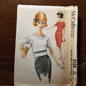 May include: McCall's printed pattern for a teen and junior two-piece dress, size 14½, bust 32. The pattern shows a white top with a black belt and a black skirt.