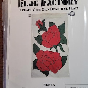 May include: A sewing pattern for a flag featuring two red roses with green leaves. The pattern is titled "Roses" and is from The Flag Factory. The pattern is designed for flags that finish at 28 inches by 49 inches. The pattern includes instructions for sewing the flag. The pattern is a division of Mutual Industries, 1400 Goldmine Rd., Monroe, NC 28110.
