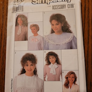 May include: A sewing pattern for a collar accessory. The pattern shows four different styles of collars, including a lace collar, a bow collar, and a ruffled collar. The pattern is from Simplicity, The Accessory Club.