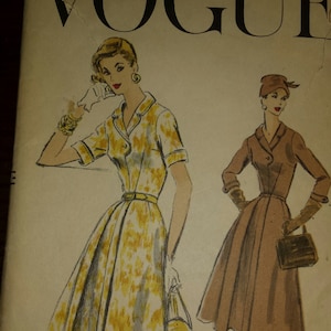 May include: A vintage Vogue sewing pattern for a dress with two different styles. The pattern number is 8887-75C and the size is 18 with a 36 inch bust and 39 inch hip.
