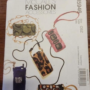 May include: A sewing pattern for five different phone cases. The cases are made of fabric and have different patterns, including leopard print, snakeskin, and a jeweled design. The pattern is from McCall's Fashion Accessories and is size OSZ.