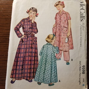 May include: Vintage McCall's sewing pattern for a girl's robe in two lengths. The pattern is for size 6 and costs 45 cents. The pattern shows three girls wearing different robes, one in a plaid pattern, one in a floral pattern, and one in a solid blue pattern.