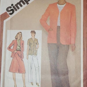 May include: Simplicity sewing pattern number 9870, size 12 miss, for a jacket and pants. The pattern shows a woman wearing a peach colored jacket and brown pants. The pattern also shows two other women wearing different versions of the jacket and pants.