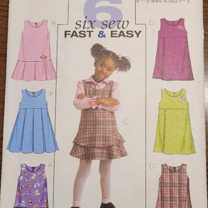 May include: A sewing pattern for six easy-to-sew dresses for girls. The pattern is for sizes 4-5-6 and is from Butterick. The pattern includes a variety of styles, including a plaid dress, a floral dress, and a solid color dress.