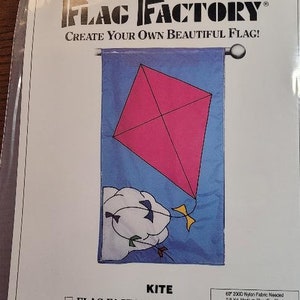 May include: A Flag Factory pattern for a kite. The pattern is designed for flags that finish 28 inches by 49 inches. The pattern includes a list of fabric needed in yards, including medium blue, burnt yellow, hot pink, red, white, dark purple, mint green, and turquoise. The pattern is a division of Mutual Industries, 1400 Goldmine Rd. Monroe, NC 28110.