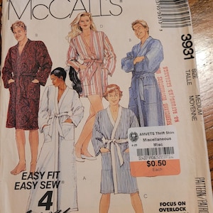 May include: A McCall's 3931 sewing pattern envelope for robes in size medium. The front displays illustrations of four different robe styles with various patterns, including paisley, stripes, and solid colors, labeled with letters A, B, C, and D.