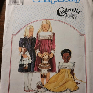 May include: Simplicity Cinderella sewing pattern, size 8, featuring illustrations of three young girls in dresses with dolls. The pattern cover has a white background with blue text and a Cinderella logo.