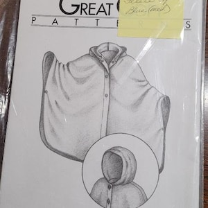 May include: A sewing pattern for a three-season cape, with a drawing of the cape and a note that says "Fleece cape Blue (med)". The pattern is number 2000.