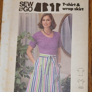 May include: A vintage sewing pattern for a t-shirt and wrap skirt. The pattern is for size 14 and is from Butterick's Instant Fashion Patterns line. The pattern is called "Sew & Go" and the pattern number is 5323. The pattern is for moderate stretch knits only.