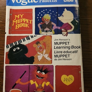 May include: Vogue Patterns craft pattern number 8902 for making Muppet characters. The pattern includes instructions for making a Muppet book, a Muppet character playing a keyboard, a Muppet character playing a drum, and a Muppet character holding a heart with the word "ANN" on it.