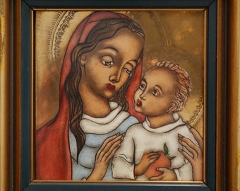 May include: A framed painting depicting a mother and child. The mother is wearing a red and blue robe and has dark hair. The child is wearing a white robe and is holding a red fruit. The painting is set against a gold background.