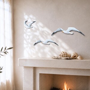 Hand-painted wooden seagulls above a fireplace – coastal wall decor