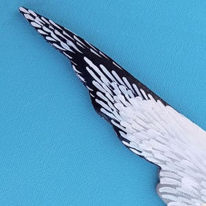 Detail of hand painted wooden seagull wing sculpture