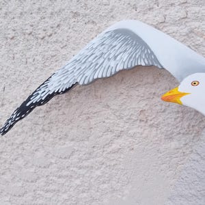 Hand-painted wooden seagull close-up – detailed view of craftsmanship and brushwork