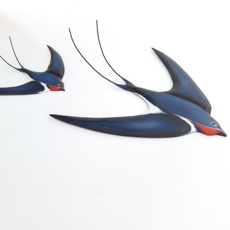 A Couple of Minimalist Painted Wooden and Metal Barn Swallows in Flying