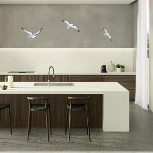 Coastal wall art installation with flock of hand painted wooden seagulls in kitchen space