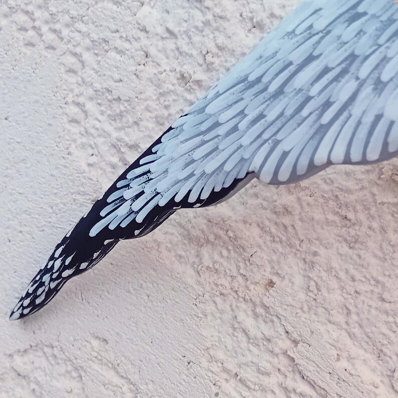 Close-up of wooden seagull’s wing with black tip – hand-painted coastal decor