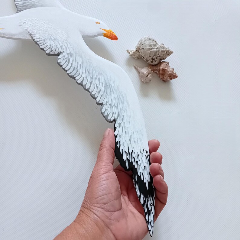 Wooden seagull sculpture detail from a large coastal wall installation