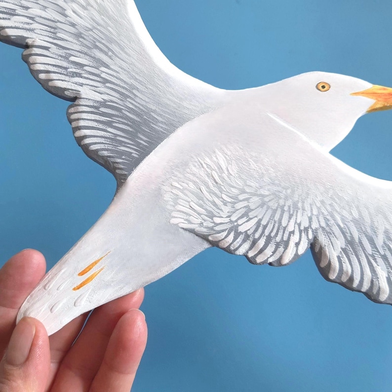 White hand painted wooden seagull sculpture, flying bird wall art detail